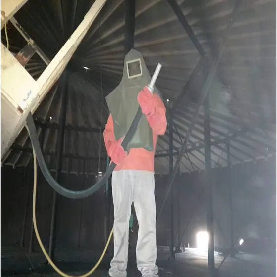 Rehabilitation of 52 metre diameter tank — sandblasting.